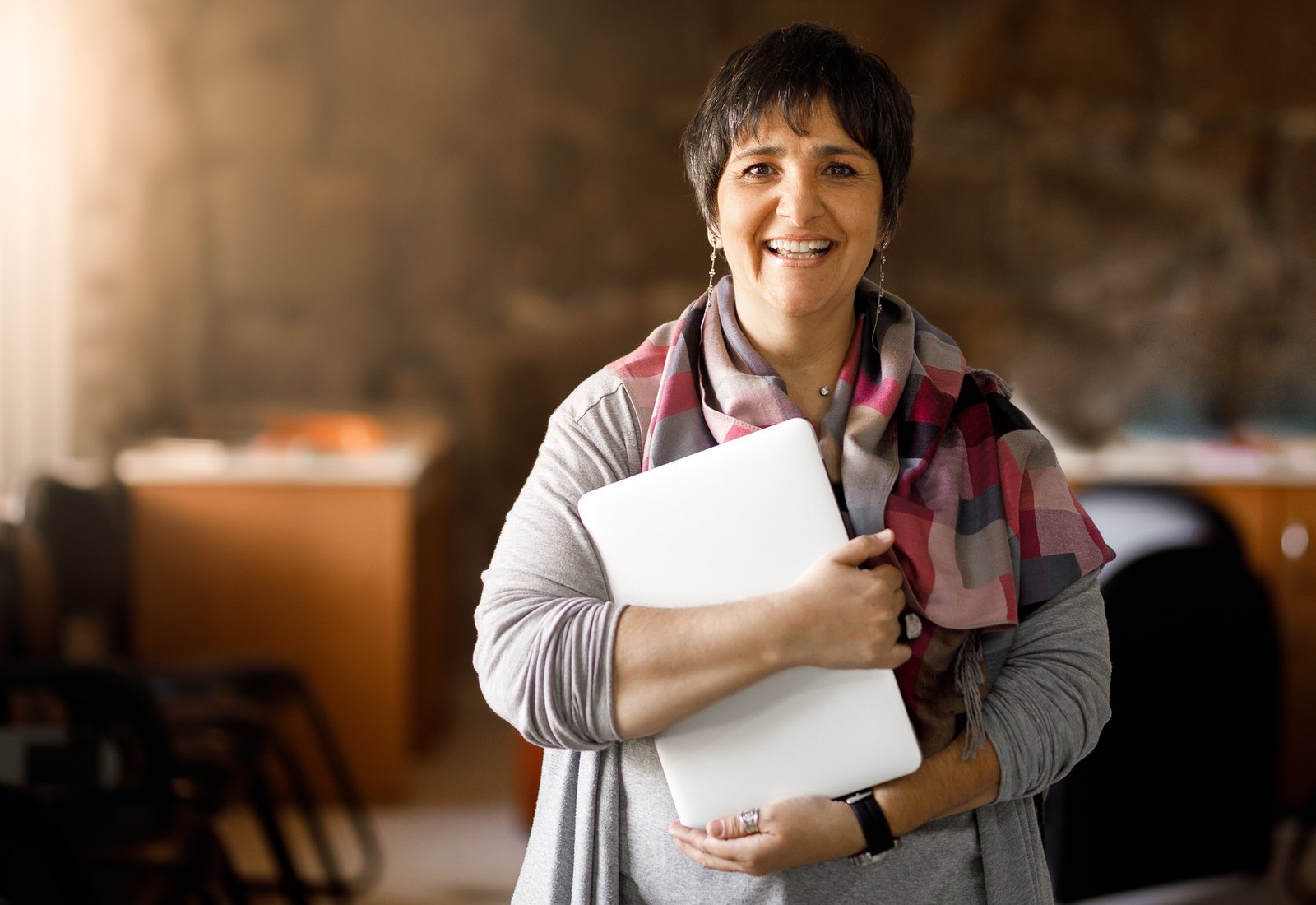 Educator holding a laptop